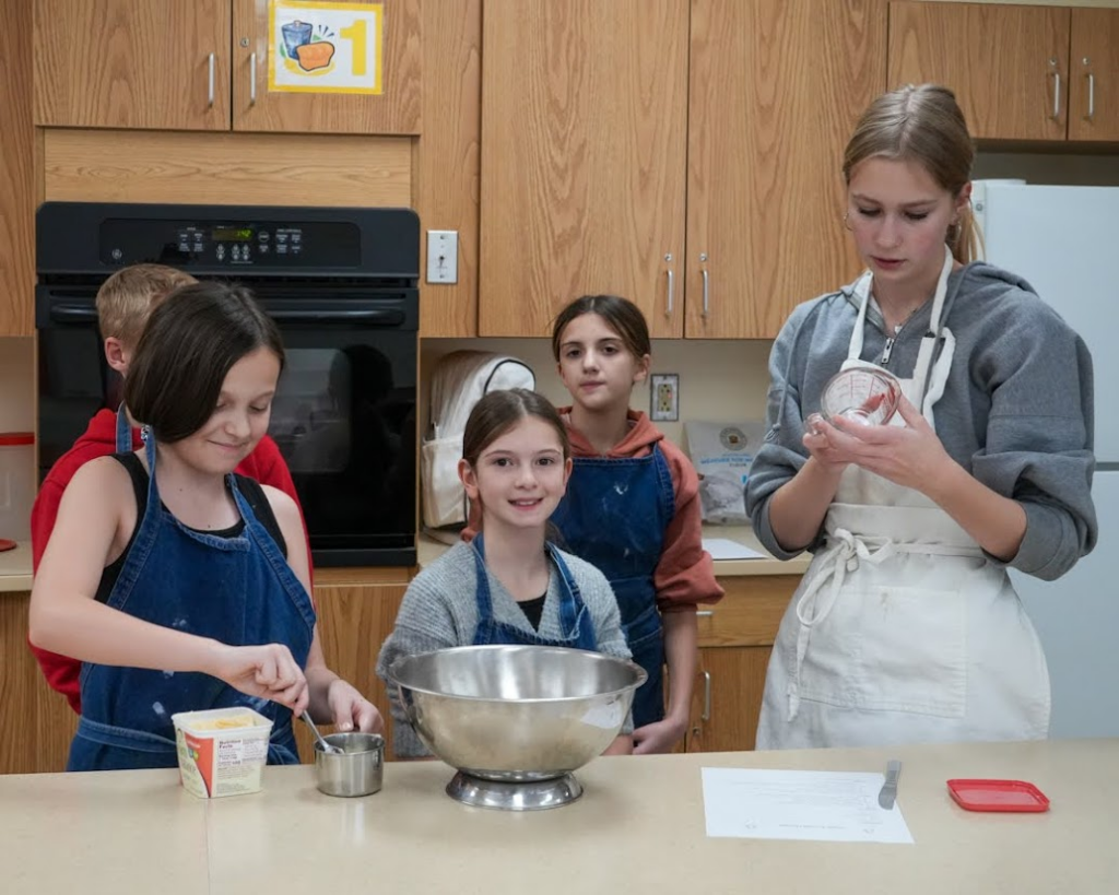 Students bake together in classroom as part of a food advocacy project.