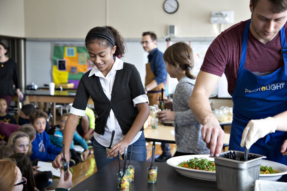 student and chef working in classroom
