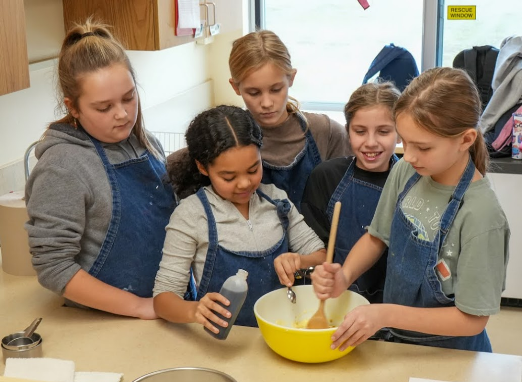 Middle school students practice cooking together in central New York.
