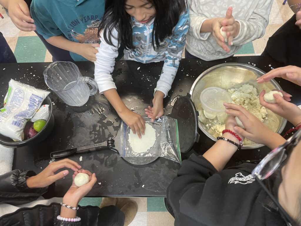 Students prepare tortillas to be made into quesadillas through Pilot Light's free Food Education lessons. 