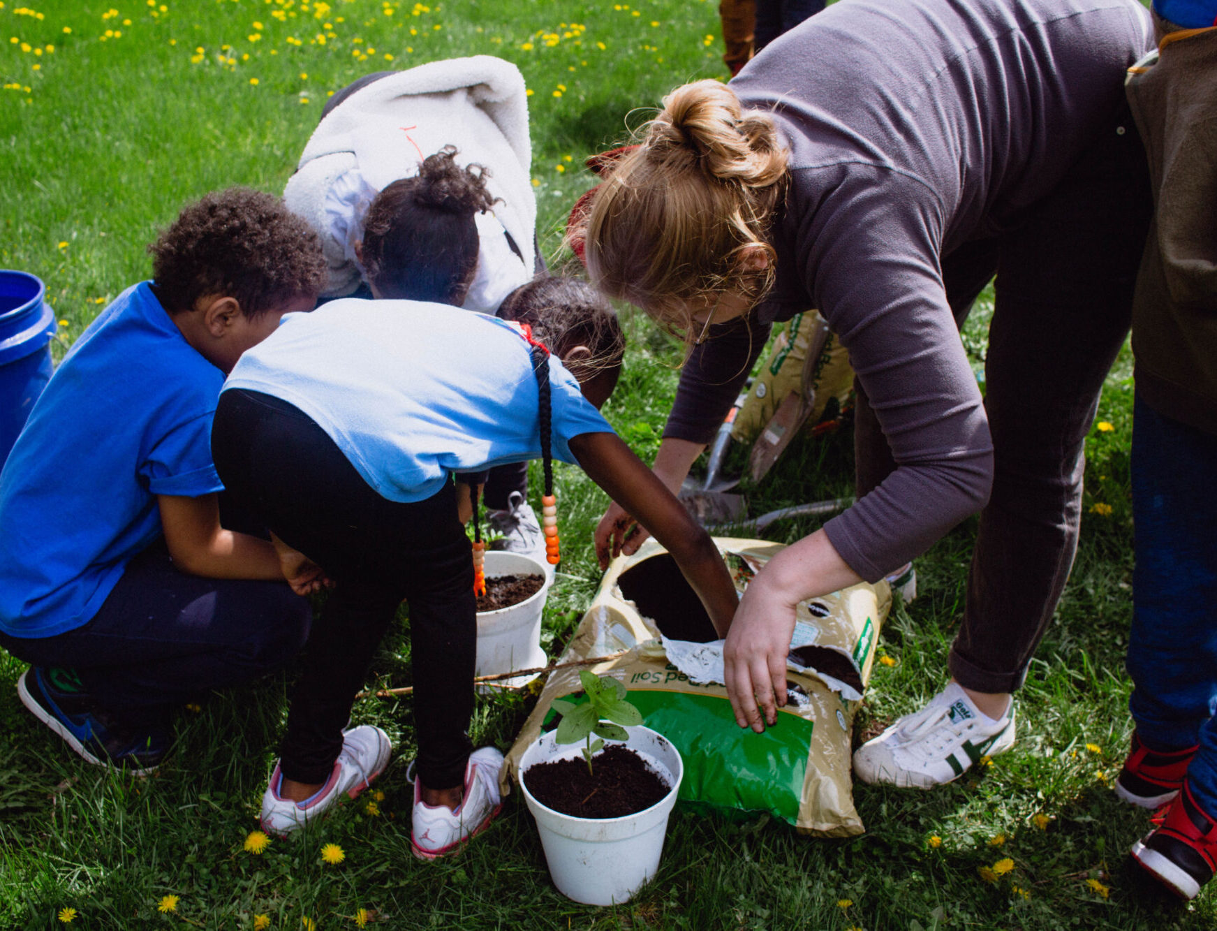 A member of the Pilot Light team works with elementary students during a special activity day.