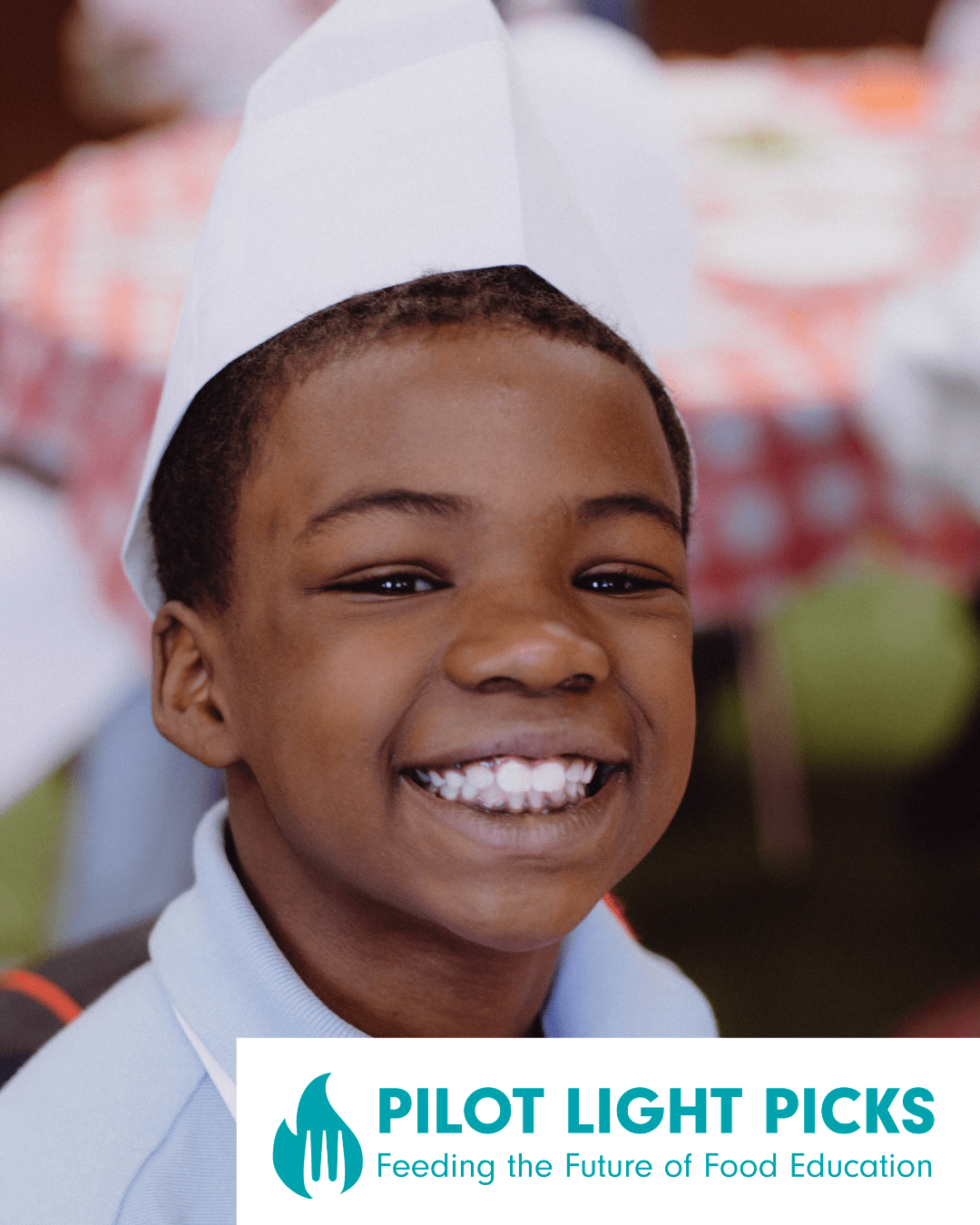 A young child wearing a chef's hat and apron smiling at the camera with the Pilot Light Picks: Feeding the Future of Food Education logo inscribed on the image.